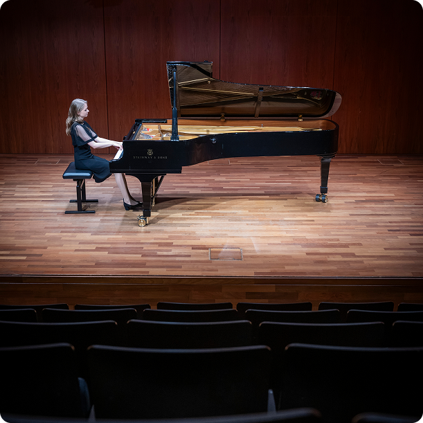 Wide shot of pianist performing on concert stage