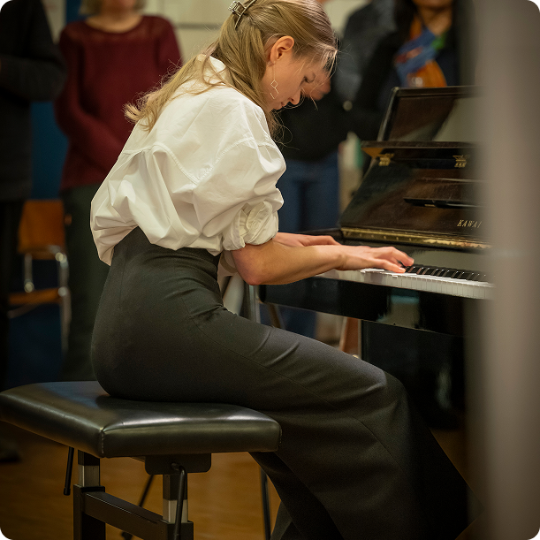 Wide shot of pianist performing on concert stage
